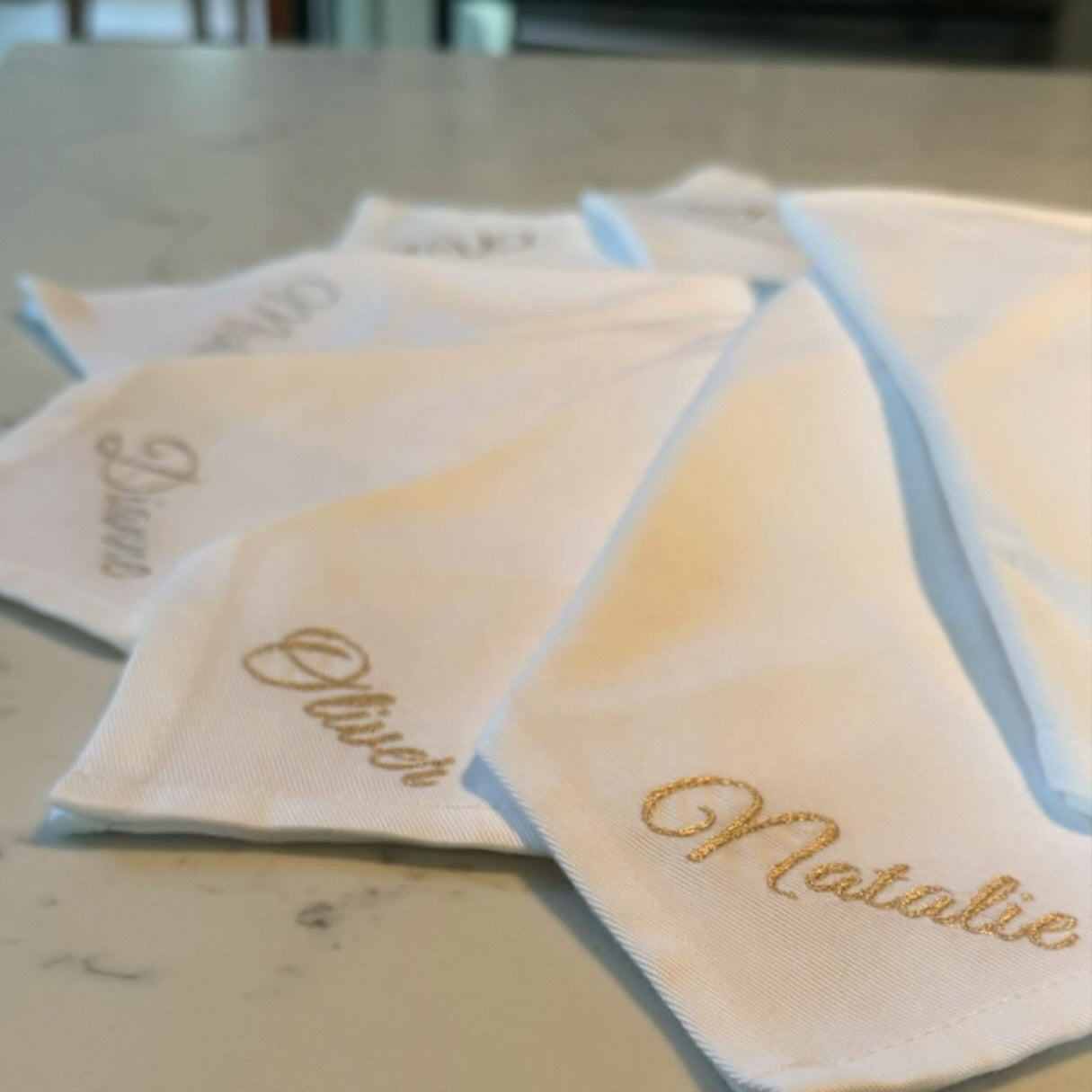 Set of personalized handkerchiefs on a marble surface