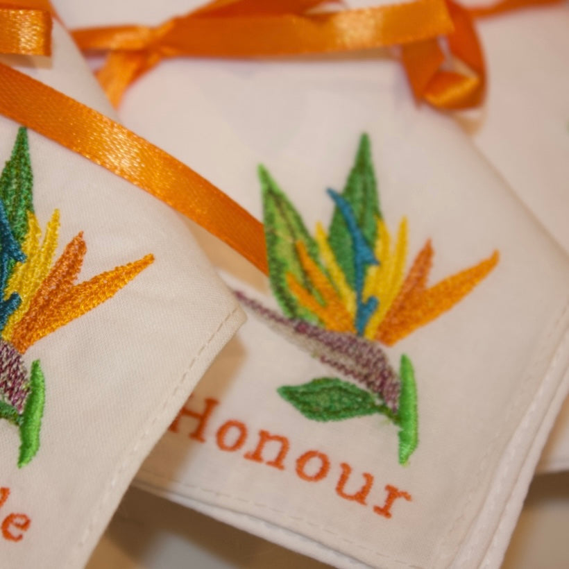 Two embroidered items with floral designs and the word 'Honour' on a white background.