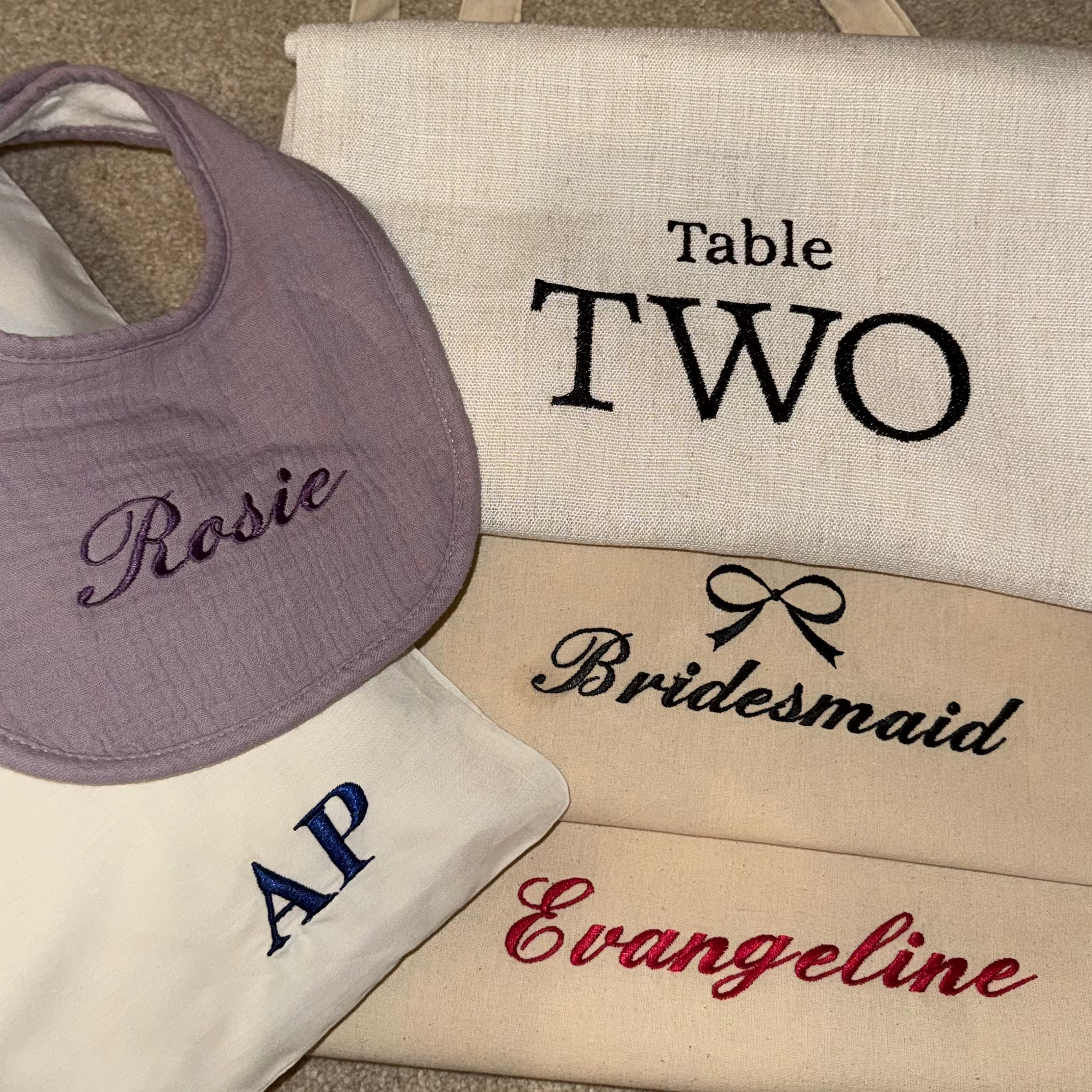 Personalized bags with names embroidered on a textured surface